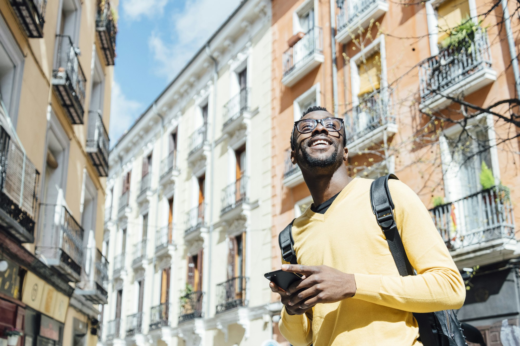 Tourist man with smartphone in the city of Madrid